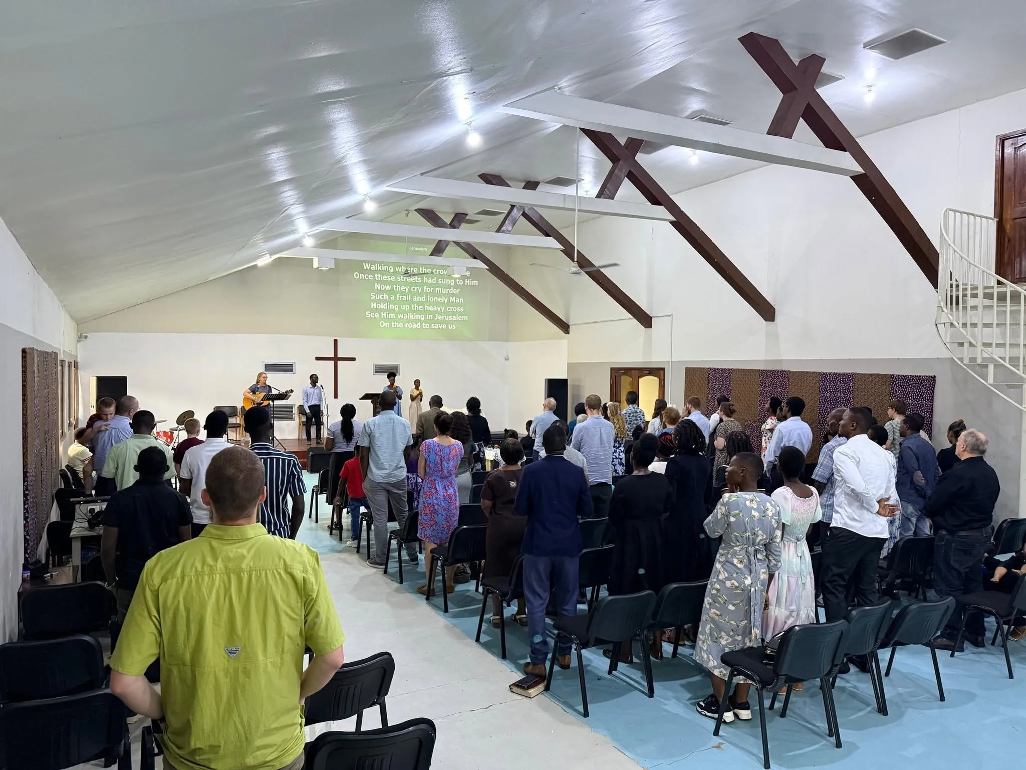 The congregation standing to sing during Sunday worship